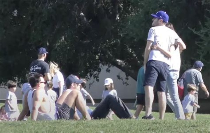 Mila Kunis standing with a group of unidentified people. | Source: YouTube/@TheHollywoodFix