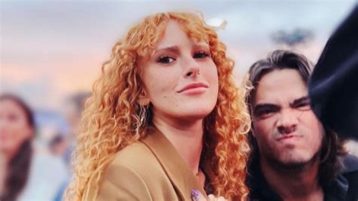 Rumer Willis smiling at the camera with Derek beside her